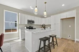 Kitchen with granite island and pendant lighting at Luna Ridge in Lenoir City, TN